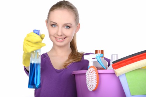 Worker checking carpet cleaning machinery and surrounding floor area